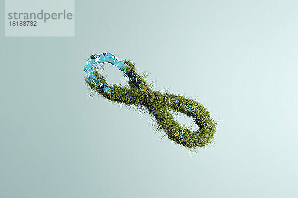 Three dimensional render of infinity symbol made of grass and water