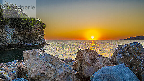 View of coastal boulders at sunrise