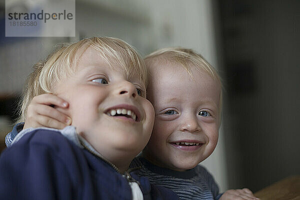 Two happy little brothers at home