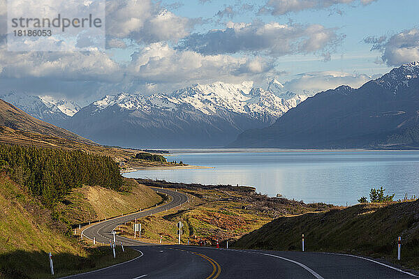 Neuseeland  Region Canterbury  kurvenreiche Asphaltstraße mit Lake Pukaki und Mount Cook im Hintergrund