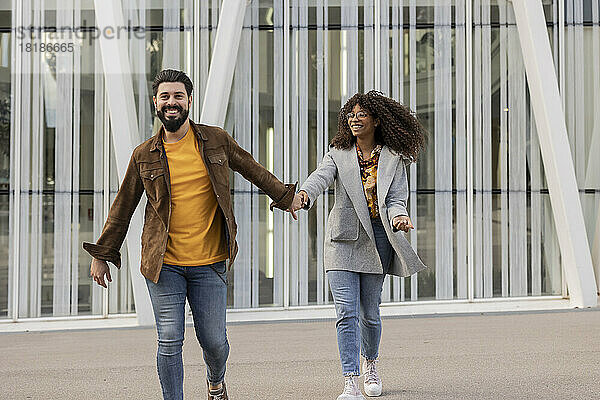 Glückliches junges Paar  das auf dem Fußweg spaziert und genießt