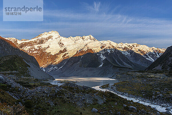 New Zealand  Canterbury Region  Hooker River and Mueller Lake at dawn with Mount Sefton in background