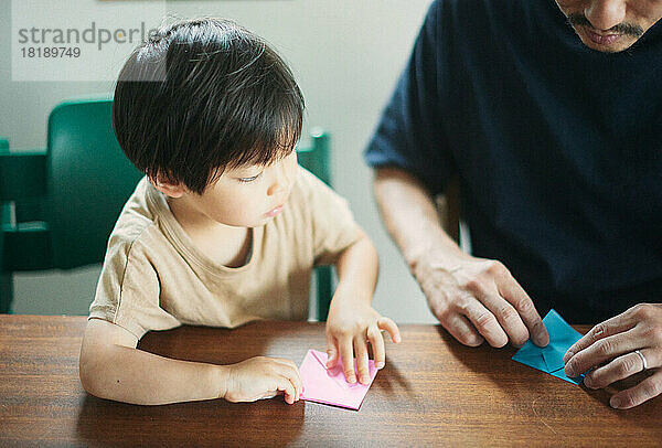 Japanese kid playing with his dad at home