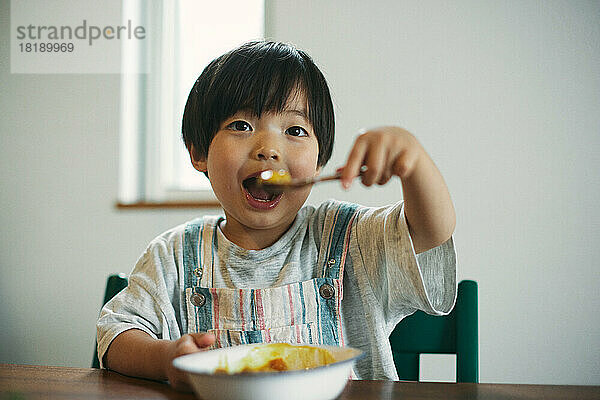 Japanisches Kind beim Essen zu Hause