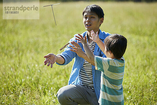 Japanese parent and child playing with bamboo copter