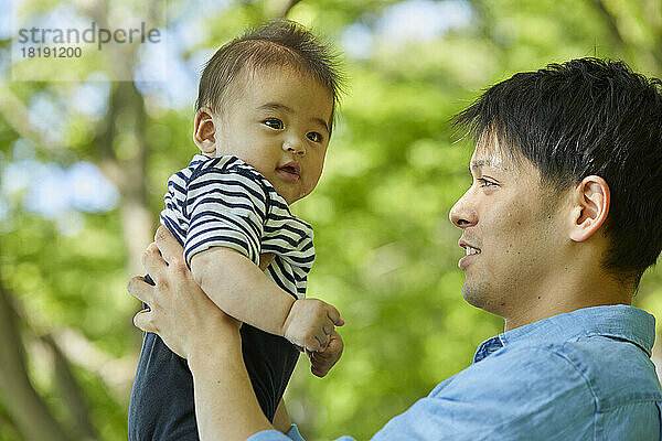 Japanischer Vater hält Baby