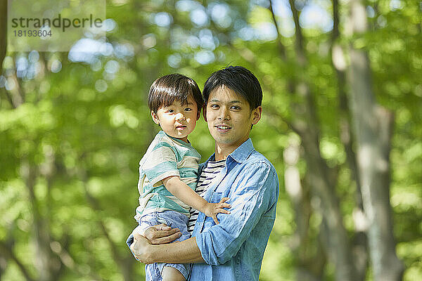 Japanese father holding his child