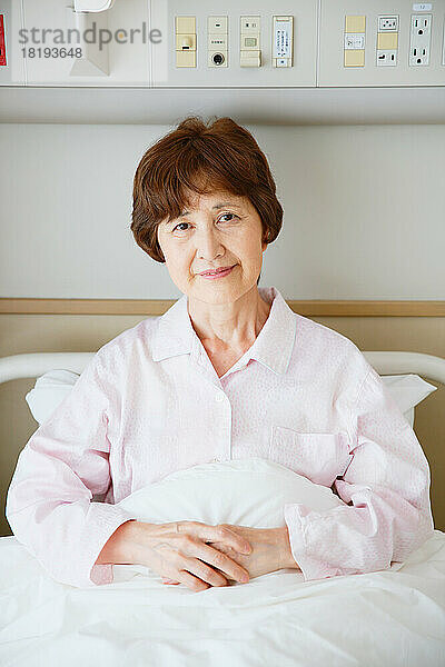 Senior Japanese woman in hospital room