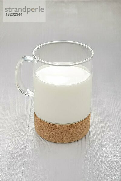 Glas Milch auf weißem Holzküchentisch