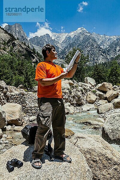 Wanderer  der auf einer Wanderung im Himalaya-Gebirge die Wanderkarte studiert. Himachal Pradesh  Indien  Asien