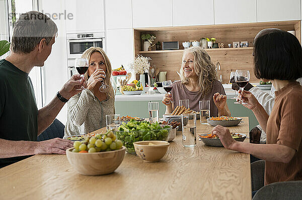 Diverse group of middle-aged friends having together at home