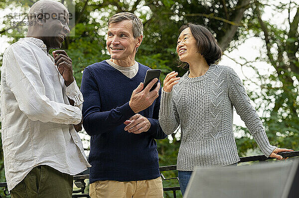 Portrait of three diverse friends enjoying each other's company inpublic park