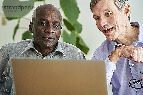 Two male business partners working together from home