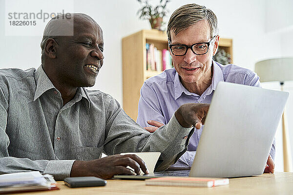 Two male business partners working together at office