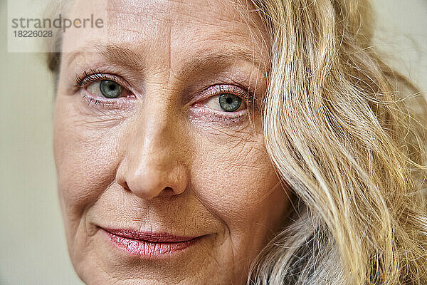 Close up portrait of senior woman against white background