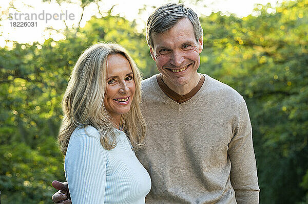 Portrait of happy middle-aged heterosexual couple posing outdoors