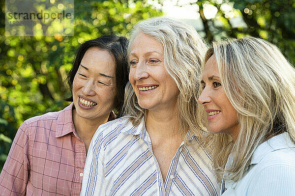 Group of diverse life-long lady friends posing for photo outdoors