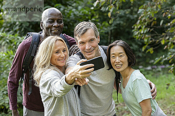 Diverse group of middle-aged friends taking a selfie while out on the backroad trails