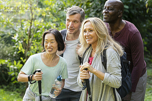 Group of diverse senior friends taking a break in their hike to pose for a photo