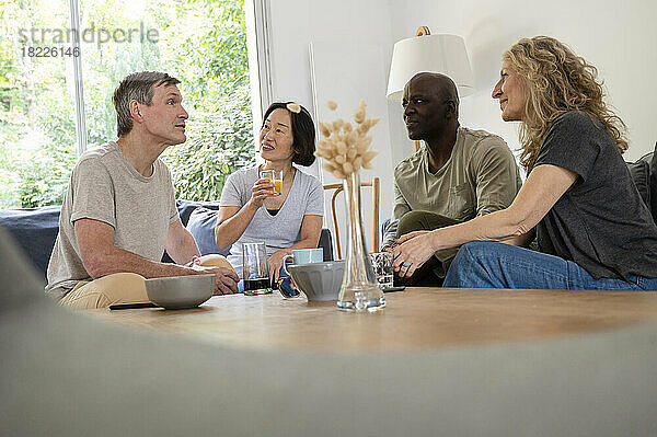 Portrait of diverse group of friends hanging out together at home