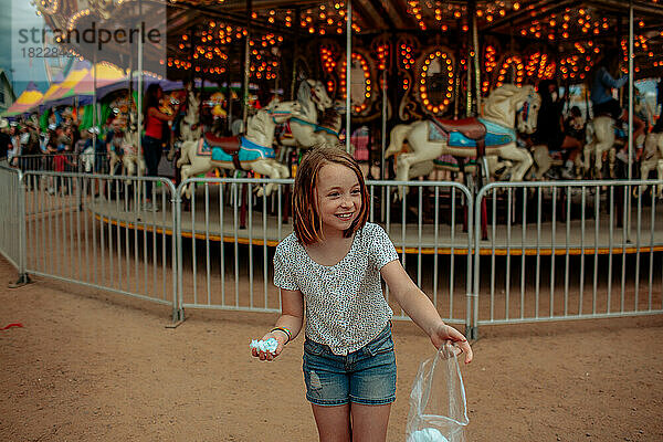 Junges Mädchen lächelt und lacht vor einer Karnevalsfahrt