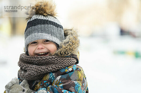 Happy boy wearing warm clothing in winter