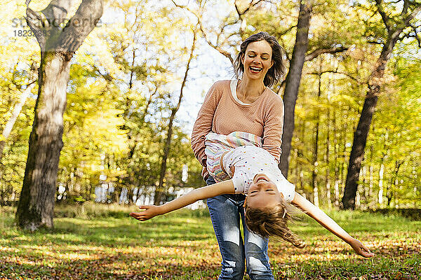 Glückliche Frau mit Tochter genießt den Park