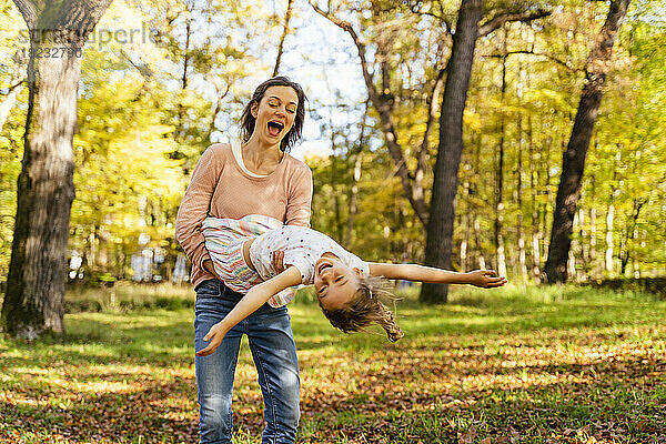 Glückliche Mutter mit Tochter  die sich im Park vergnügt