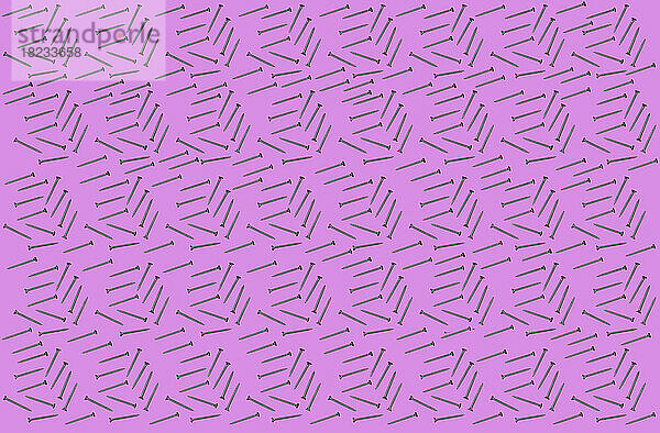 Muster aus Reihen flach gelegter Schrauben vor rosa Hintergrund