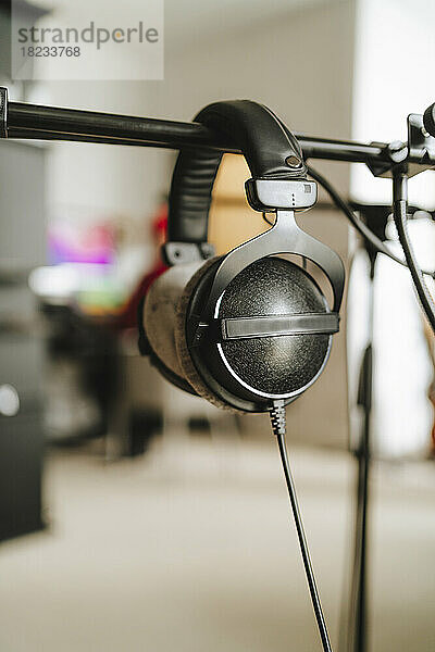 Black headphones in empty recording studio