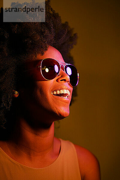 Happy young woman wearing illuminated sunglasses