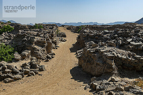 Empty dirt road amidst rocks at Al-Ukhdud Archaeological Site in Najran  Saudi Arabia