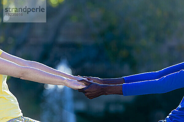 Multiracial couple holding hands of each other