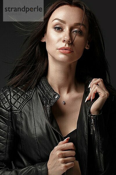 Gewagtes Mädchen Modell in schwarzem Lederkleid  Stil des Rock  dunkles Make-up und Schönheit Haar. Bild im Studio aufgenommen