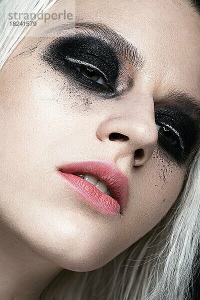 Schönes blondes Mädchen mit dunklem Smokey-Make-up. Schönheit Gesicht. Fotos im Studio geschossen