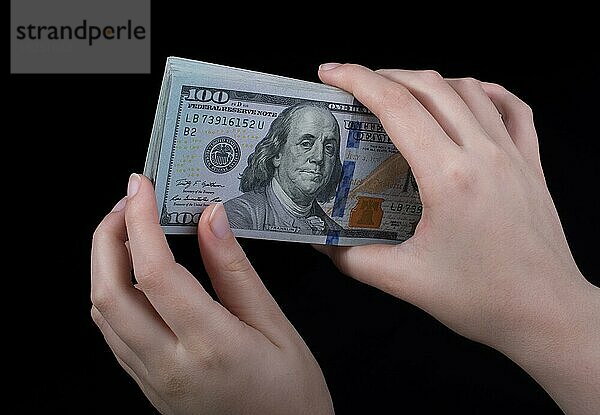 Hand hält amerikanische Dollar-Banknoten vor weißem Hintergrund