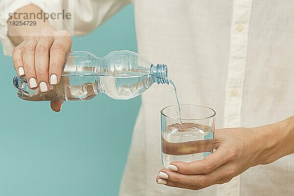 Frau gießt Wasser in ein Glas. Auflösung und hohe Qualität schönes Foto