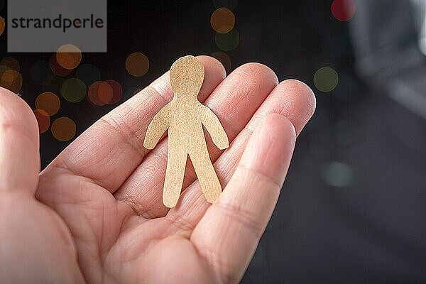 Papier Mann Form in der Hand auf Bokeh Licht Hintergrund