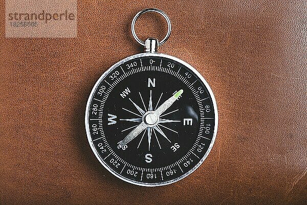 Nahaufnahme eines Kompasses auf hölzernem Hintergrund