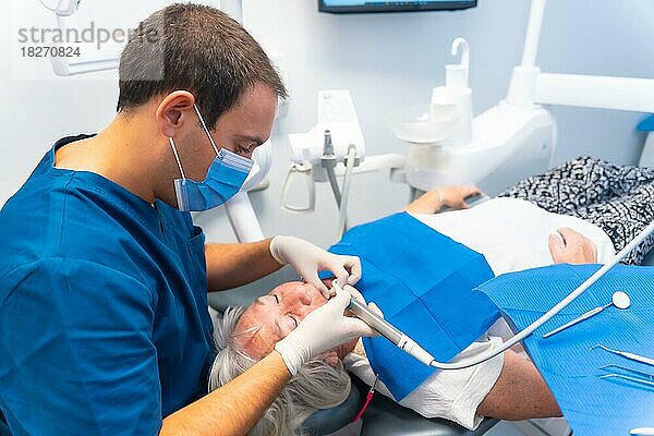 Zahnklinik  ältere Frau beim Zahnarzt  Überprüfung von Implantaten mit Zahnarzt  Gesichtsmaske