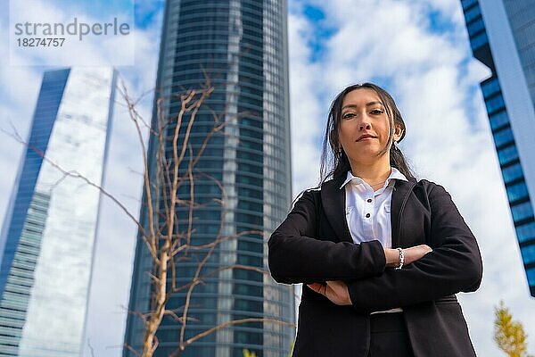 Unternehmensporträt einer lateinamerikanischen Geschäftsfrau  Gewerbegebiet  verschränkte Arme