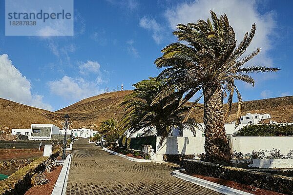 Femes  typischer Ort im Süden der Insel  weiße Häuser  Palmen  Lava-Hügel  blauer Himmel mit weißen Wolken  Femes  Lanzarote  Kanarische Inseln  Spanien  Europa