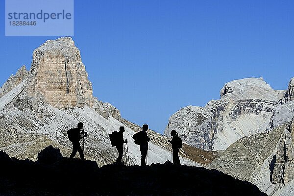 Vier Bergsteiger vor der Silhouette des Torre dei Scarperi  Schwabenalpenkopf  Sextner Dolomiten  Parco Naturale Tre Cime  Südtirol  Italien  Europa