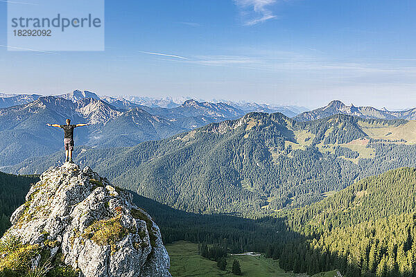 Germany  Bavaria  Male hiker standing on summit of Taubenstein mountain