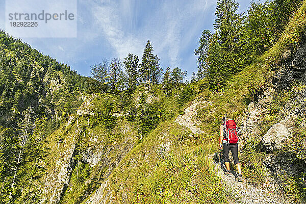 Germany  Bavaria  Female hiker walking through Rappinschlucht to Rabenkopf