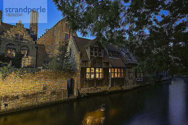 Belgium  West Flanders  Bruges  Historic houses along city canal at dusk