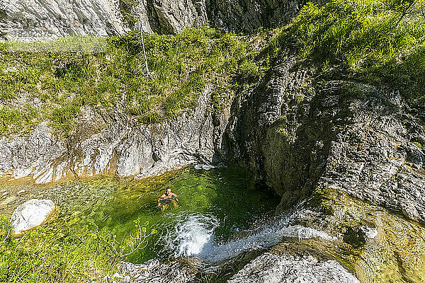 Germany  Bavaria  Male hiker cooling down in pools of Pfanngraben