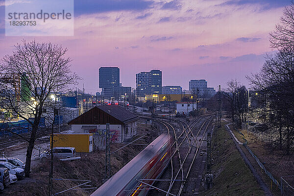 Germany  Bavaria  Munich  Moving train seen from Donnersbergerbrucke at dusk