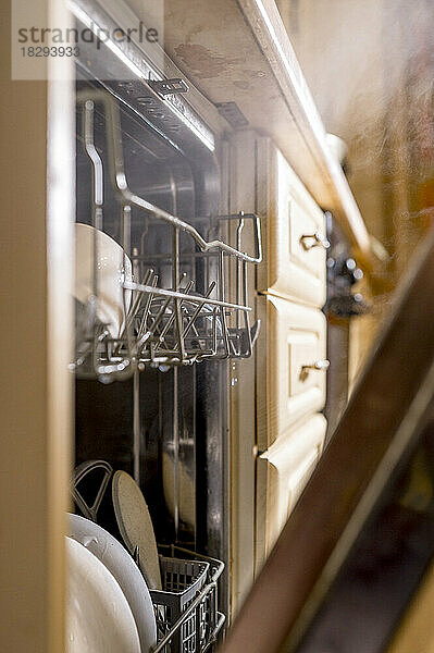 Utensils in rack of dishwasher at home