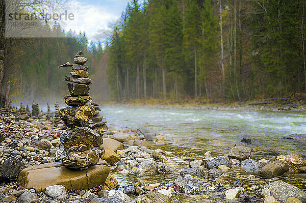 Stack of pebbles at riverbank